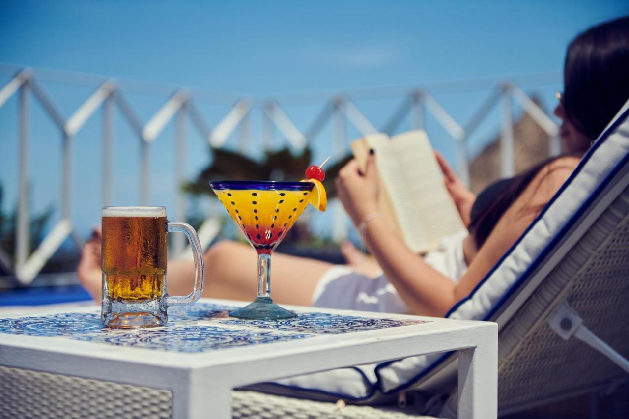 Hotel Luxury Patio Azul (Adults Only) Puerto Vallarta Kültér fotó A woman reading a book by the pool